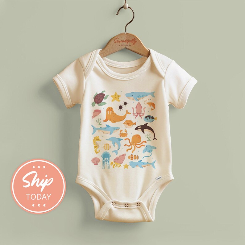 a baby bodysuit hanging on a clothes hanger