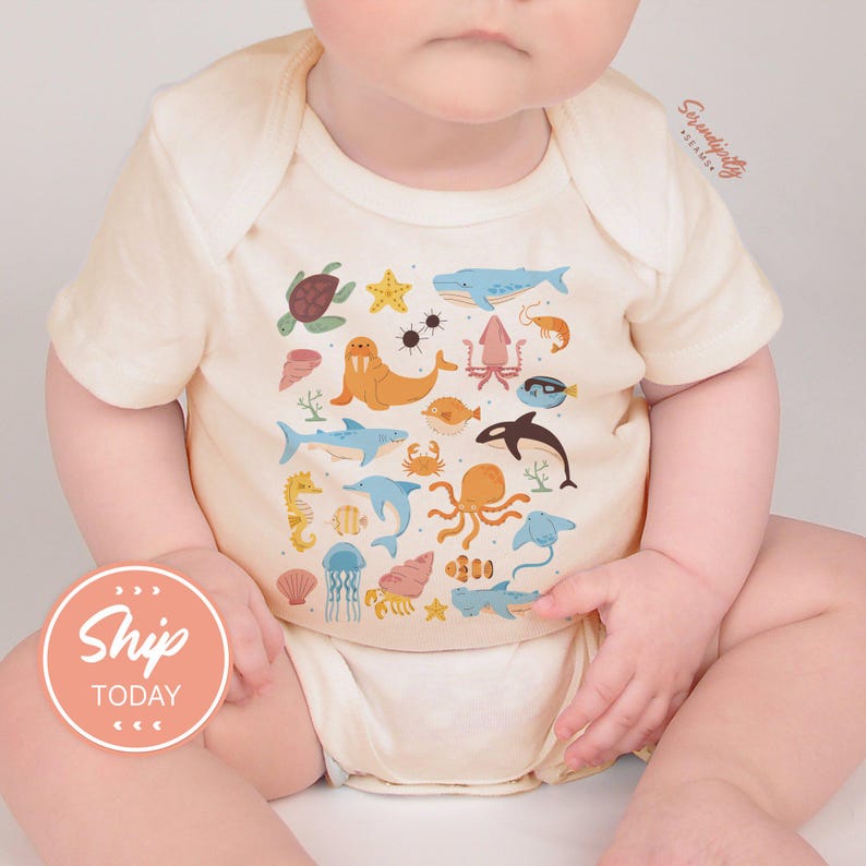 a baby is sitting on a white surface