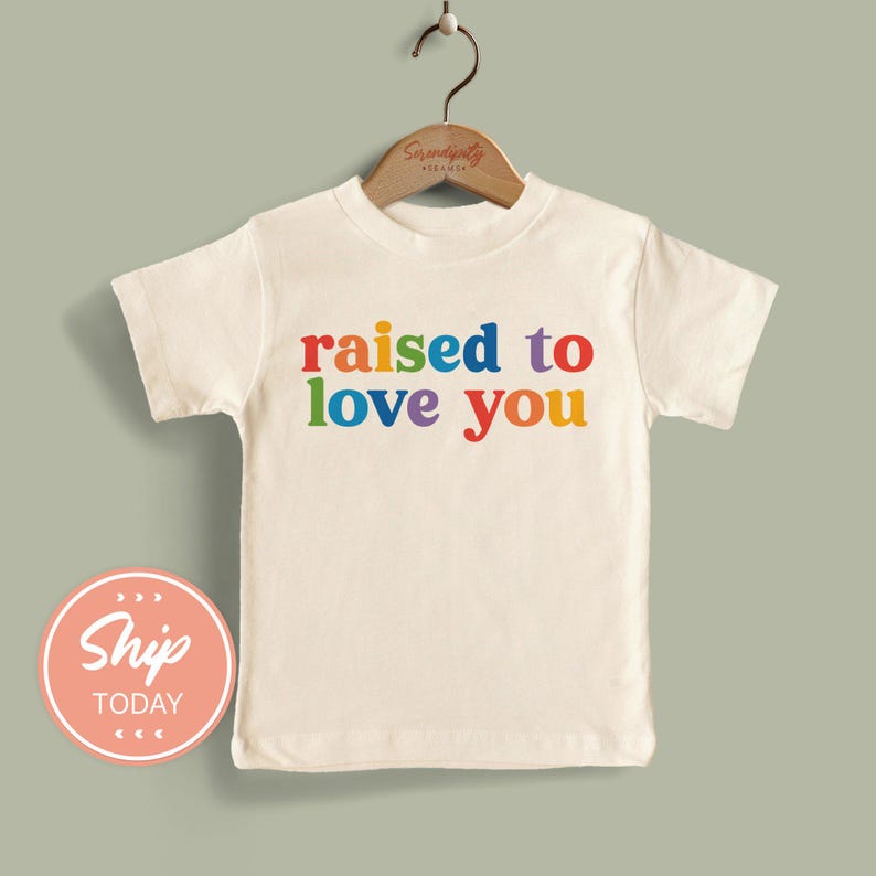 a t - shirt that says raised to love you
