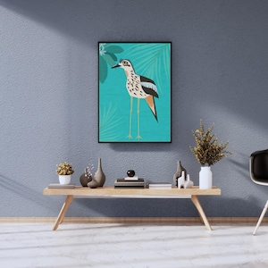May include: A framed illustration of a bird with black and white spots standing on a branch with green leaves against a turquoise background.