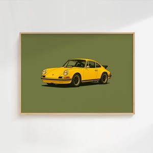 May include: A framed art print featuring a bright yellow vintage sports car centered on a solid olive green background. The illustration depicts the car from a front three-quarter angle, showcasing its rounded headlights, black wheels, and spoiler.