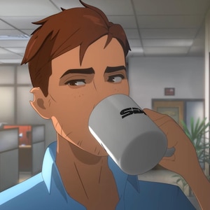 May include: Animated image of a person drinking from a white mug with the letters "SD" in black. The person is wearing a blue shirt and has brown hair. The background shows an office setting with filing cabinets and cubicles.