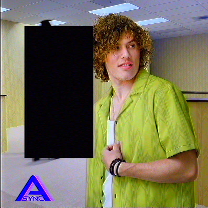Curly-haired model wearing the yellow Backrooms Level 0 wallpaper camp shirt in an office hallway