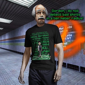 Op de afbeelding: Een zwart t-shirt met een afbeelding van een stripfiguur en tekst. De tekst op het shirt bevat "Hello, Gordon!" en "Kill. Motones!". Boven het personage staat de tekst "Gordon, I do not detect bad shirts in a ten meter radius!"