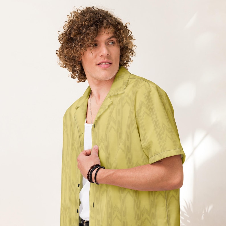 Curly-haired model wearing the yellow Backrooms button-up shirt, front studio view