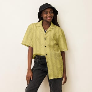 Model in a bucket hat and black pants wearing the Backrooms wallpaper button-up shirt, liminal space outfit