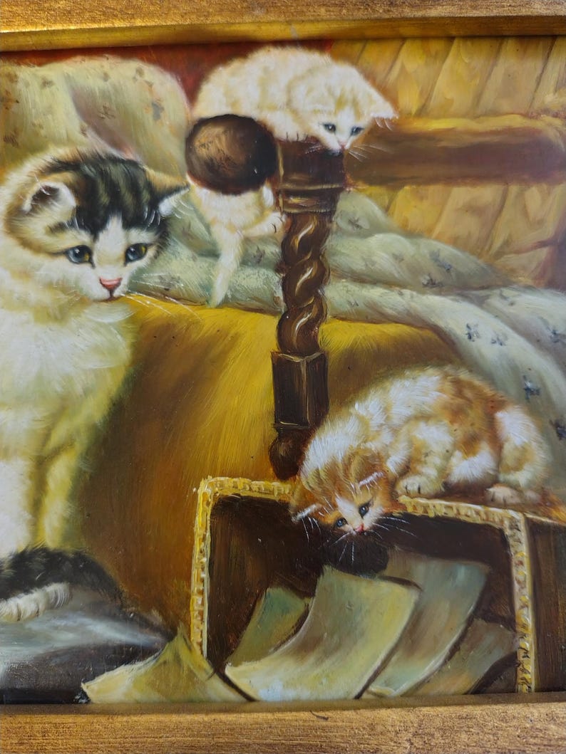 May include: A painting of three kittens in a cozy setting. One kitten is white and perched on a wooden post, another is black and white and lying down, and the third is orange and white and looking into a box.