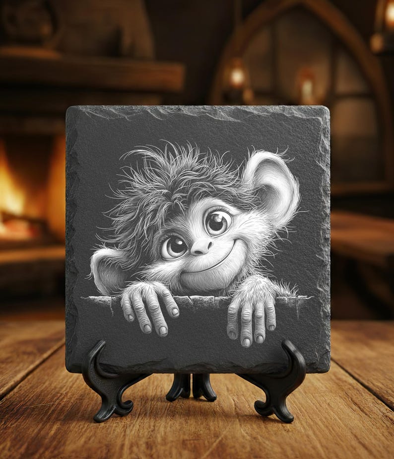 May include: A black slate coaster featuring a whimsical cartoon monkey with large eyes and a friendly smile. The monkey's hands are resting on the edge of the slate. The coaster is displayed on a black stand.