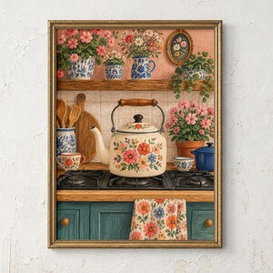 May include: A framed wall art print depicting a kitchen scene with a floral-patterned tea kettle on a black hob. The scene includes shelves with potted flowers, wooden utensils, a blue pot, and a floral towel hanging on teal cabinets.