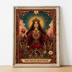 May include: A framed wall art print depicting a tarot card titled THE HIGH PRIESTESS. The central figure wears a crown and red robes, holding a red apple and a staff. The design features a heart with an eye, floral elements, and a crescent moon.