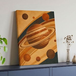 May include: A rectangular canvas wall art print featuring a large, central ringed planet in shades of brown and tan. The composition includes several smaller spherical celestial bodies against a background of diagonal stripes in ochre and dark blue.