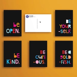 May include: Six black cards with colorful text on each. The text on the cards reads: "Be Open", "Be Your-Self", "Be Kind", "Be Curi-ous", "Be a Gold-Fish".