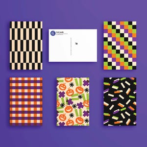 May include: A collection of six postcards with various patterns. Designs include black and beige vertical stripes, orange and purple plaid, and Halloween-themed illustrations with pumpkins and stars. The postcards are arranged on a purple background.