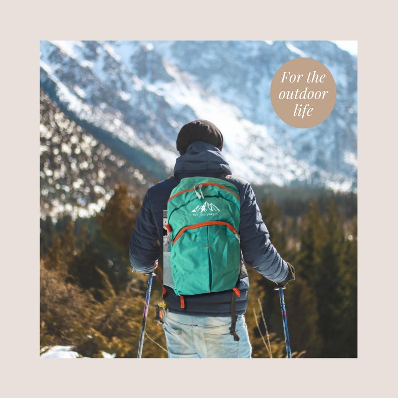 May include: A person wearing a dark blue jacket and light blue jeans, carrying a teal backpack with orange accents, hiking in a snowy mountain landscape. The backpack has a mountain logo and the text "For the outdoor life".