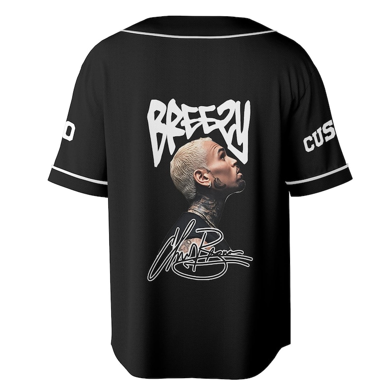 May include: Black baseball jersey with white trim and sleeves. The back features a portrait of a person with the word "Breezy" in white above the portrait and a signature below. The sleeve has the word "CUS" in white.