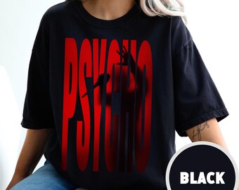 May include: A black t-shirt with a red "PSYCHO" graphic. The graphic features a silhouette of a person with their hands raised.
