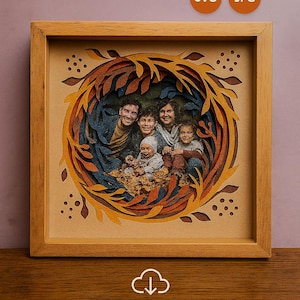 May include: A framed paper art piece featuring a family portrait. The artwork uses layered paper in shades of blue, orange, and brown to create a 3D effect. The frame is made of light-colored wood. Text at the bottom reads "DIGITAL DOWNLOAD - NO PHYSICAL ITEM."
