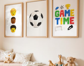 May include: Three framed prints with a sports theme. One features a soccer ball, another has three Lego-style heads, and the third says "GAME TIME" with Lego-style blocks and soccer-related icons. A wooden bench with storage and toys is below.