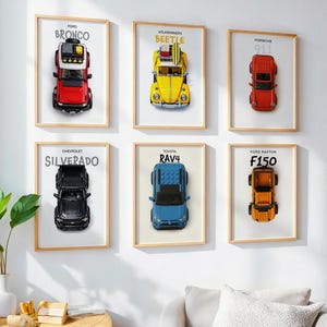 May include: Six framed prints featuring toy car models: Ford Bronco, Volkswagen Beetle, Porsche 911, Chevrolet Silverado, Toyota RAV4, and Ford F150. Each print displays the car model against a white background, with the car's name above.