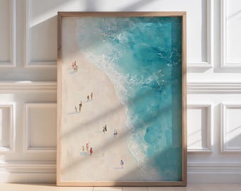 May include: A framed art print depicting a beach scene with a light brown wooden frame. The artwork shows a sandy beach with tiny figures of people and turquoise ocean waves. The word "CALYPSO" is printed at the bottom.