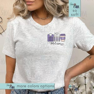 May include: A light gray t-shirt with a small graphic of dental tools, a coffee cup, and the name "Melissa RDH" in purple. The shirt also has the text "Forever ESRA so soft" and "more colors options".