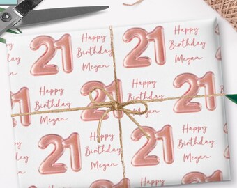 May include: White wrapping paper with a repeating pattern of rose gold number 21 balloons and the text "Happy Birthday Megan". The paper is tied with twine and includes the sizes 30x36", 30x72", and 30x180".