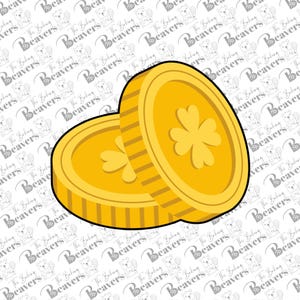 May include: Two gold-colored coins with a shamrock design. The coins are stacked slightly, with one in front of the other. The coins have a textured edge and a yellow outline. The background has a repeating pattern of a beaver and the words "The Baking Beavers".
