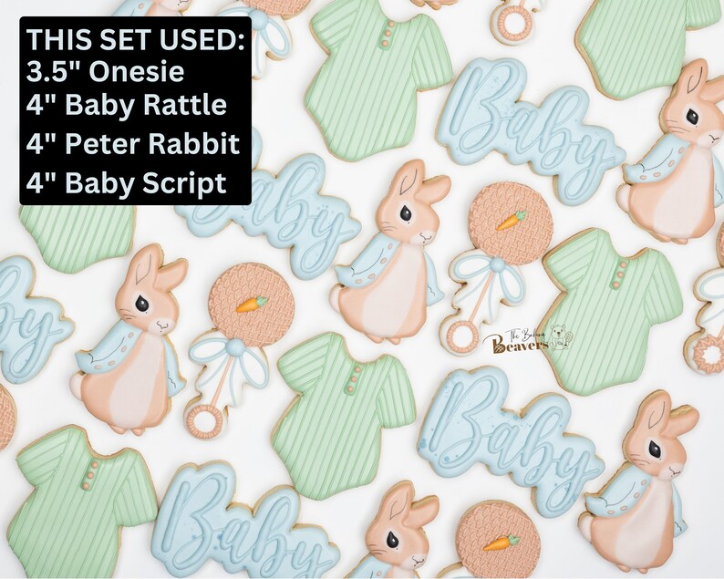 May include: A collection of baby-themed cookies, including a 3.5" onesie, 4" baby rattle, 4" Peter Rabbit, and 4" "Baby" script cookies. The cookies are decorated with pastel colors and intricate details, perfect for a baby shower or celebration.