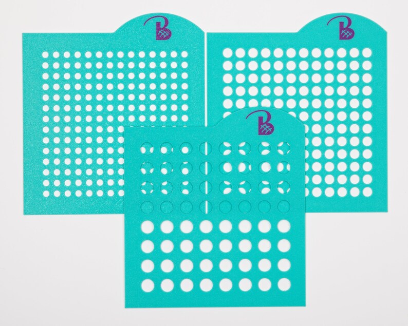 May include: Three turquoise blue stencils with circular cutouts of varying sizes. The stencils are made of a flexible material and are designed for crafting projects.