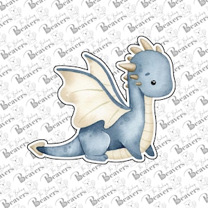 May include: A blue and cream-colored dragon cookie cutter with a watercolor-style illustration. The dragon features large wings, a long tail, and small horns on its head. The design is outlined in a thick white border against a repeating logo background.