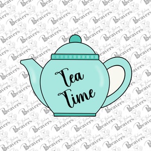 May include: A light blue teapot-shaped cookie cutter with the words "Tea Time" in black script. The teapot has a handle, spout, and a lid with a small knob. The design is simple and clean.