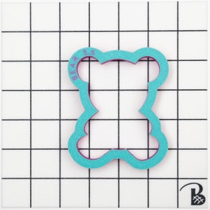 May include: A turquoise blue plastic cookie cutter shaped like a bear with the text "BEAR 3.5" on the top.