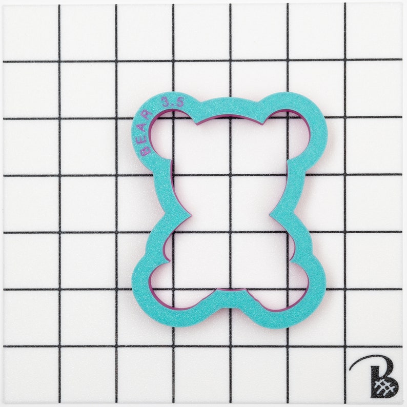May include: A turquoise blue plastic cookie cutter shaped like a bear with the text "BEAR 3.5" on the top.