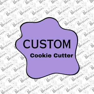 May include: Purple and white graphic with the text "CUSTOM Cookie Cutter" in black.