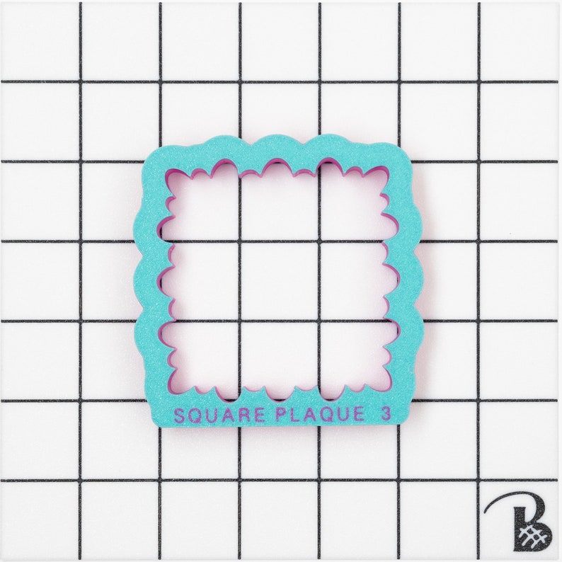 May include: A turquoise blue and purple square plaque cookie cutter with a scalloped edge. The cutter is on a white grid background. The text "SQUARE PLAQUE 3" is printed on the cutter.