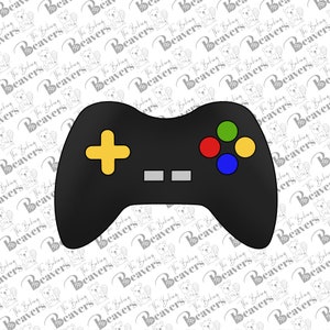 May include: A black video game controller with a yellow plus sign, two gray buttons, and four colored buttons. The buttons are red, green, blue, and yellow.
