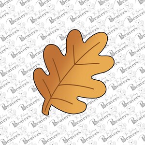 May include: A single, golden brown oak leaf with a slightly textured surface. The leaf is isolated against a white background.