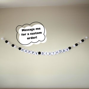 May include: Black and white balloon garland spelling "Happy Birthday" with a white speech bubble that says "Message me for a custom order!"