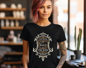 May include: Black t-shirt with a vintage-style graphic design featuring a book and the text "Dark Just Enjoy The Ride Romance".