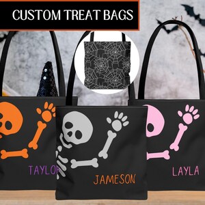 May include: Black tote bags with Halloween skeleton designs in orange, white, and pink. The bags have the names "Taylor", "Jameson", and "Layla" printed on them. The top of the image reads "CUSTOM TREAT BAGS".