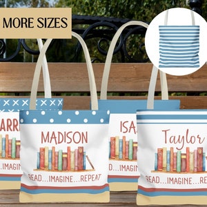 May include: Four personalized tote bags with blue and white striped fabric. Each bag features a stack of colorful books with the text "READ...IMAGINE...REPEAT" and a personalized name: "HARR", "MADISON", "ISA", and "Taylor".