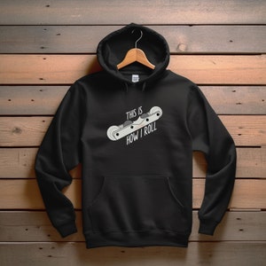 May include: Black hooded sweatshirt with a white graphic of a roller skate and the text "This is how I roll".