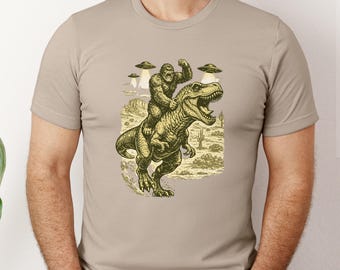 Bigfoot  Riding Dinosaur T Shirt Funny T Shirts for Men Women UFO T Shirt Offensive Shirt  Graphic T Shirts Crazy Shirts T Rex Novelty Tee