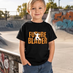 May include: A black short-sleeved t-shirt featuring the orange text "FUTURE BLADER" with a white silhouette of a person on inline skates positioned between the words. The shirt is paired with blue denim jeans, creating a casual outfit.