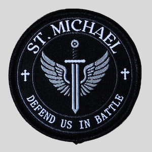 May include: Black embroidered patch with the words "ST. MICHAEL DEFEND US IN BATTLE" in white. The patch features a sword, wings, and crosses. The patch is circular.