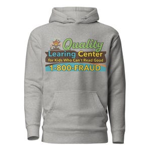 May include: A heather gray hoodie with a kangaroo pocket and a drawstring hood. The front features a graphic with the text "Quality Learing Center for Kids Who Can't Read Good 1-800-FRAUD" in various colors.