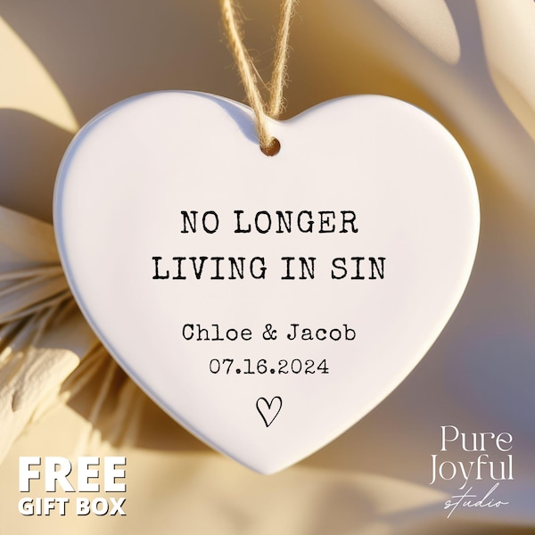 May include: White ceramic heart ornament with the text "NO LONGER LIVING IN SIN" and the names "Chloe & Jacob" and the date "07.16.2024".