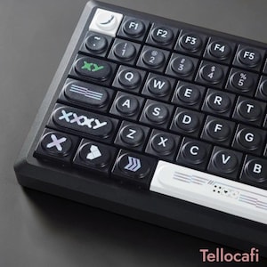 May include: A black mechanical keyboard with white and green accents. The keyboard features custom keycaps with symbols and text. The keys are arranged in a standard QWERTY layout. The keyboard has a sleek, modern design.