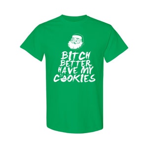 May include: Green t-shirt with a white graphic of Santa Claus and the text "Bitch Better Have My Cookies".