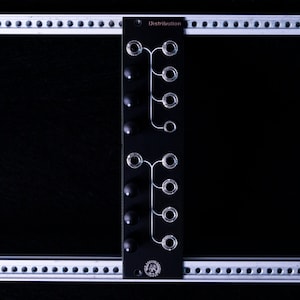May include: A black Eurorack module with the text "Distribution" printed on the front. The module has eight knobs and eight jacks, arranged in two rows of four. The module is mounted on a silver rack.